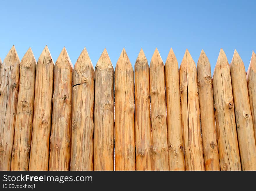 Wooden paling from the sharp raw logs