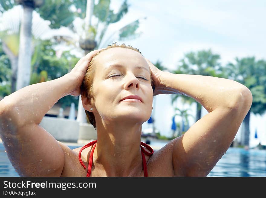 Portrait of nice young woman relaxing in swimming pool. Portrait of nice young woman relaxing in swimming pool