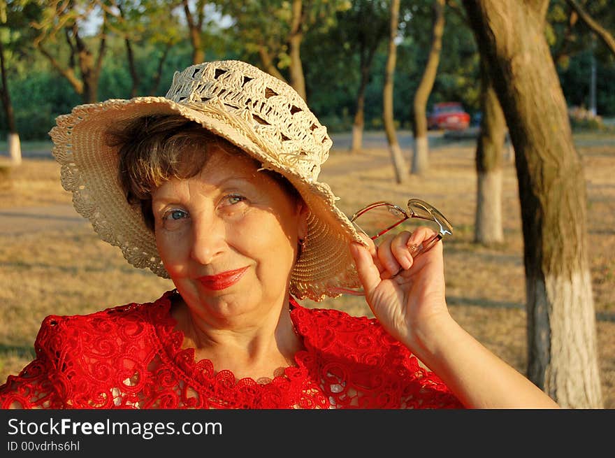 The elderly woman, smile, hat, sunset. The elderly woman, smile, hat, sunset.