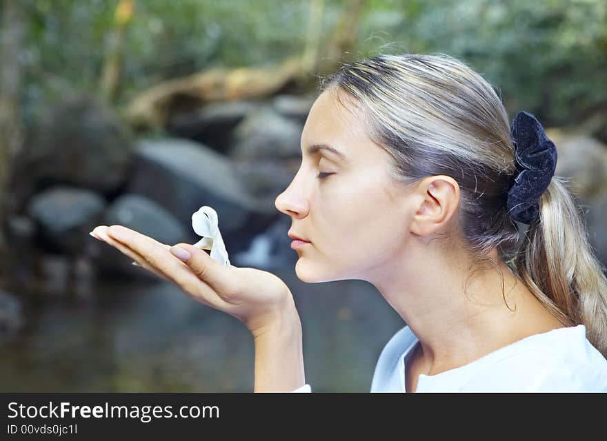 Portrait of fresh and beautiful human with flower in summer environment