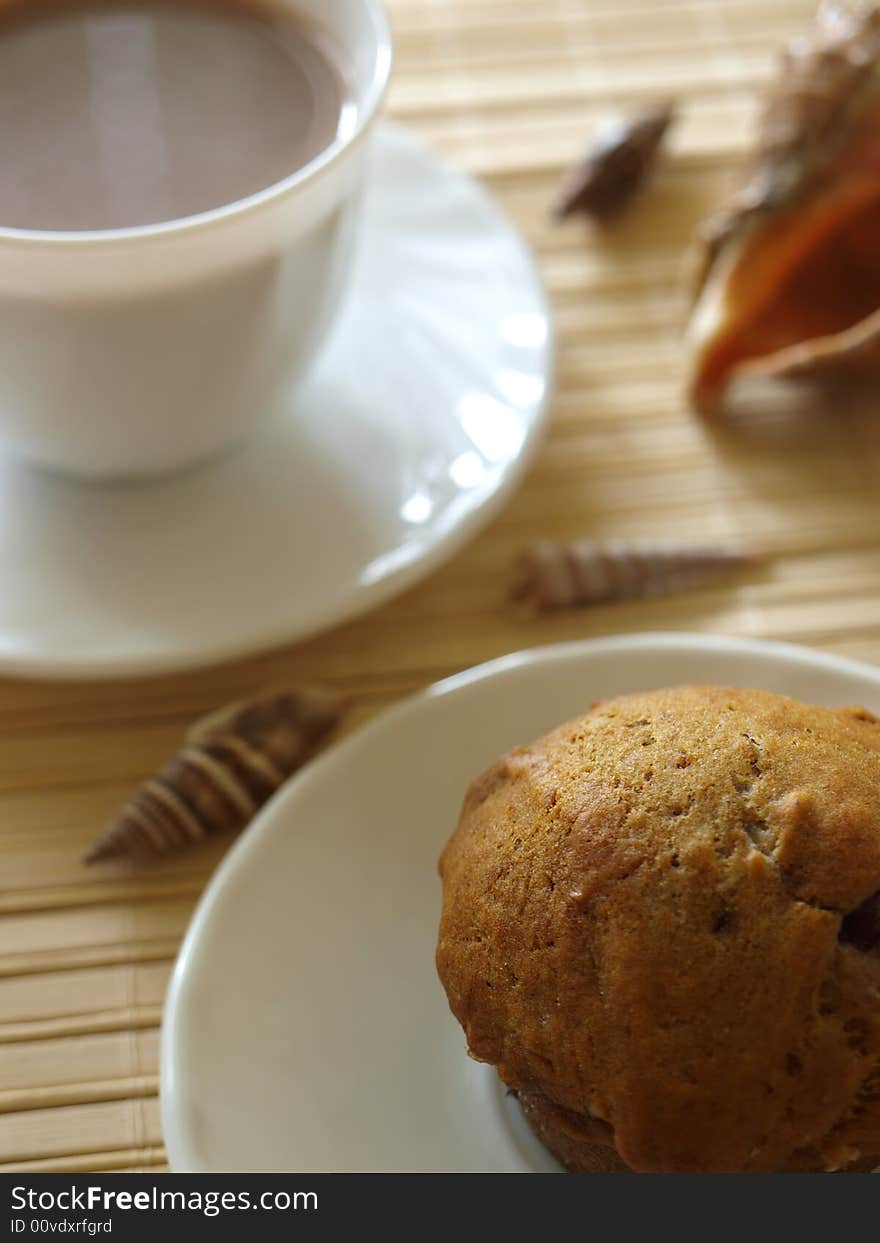 Close up muffin with cup of coffee in background