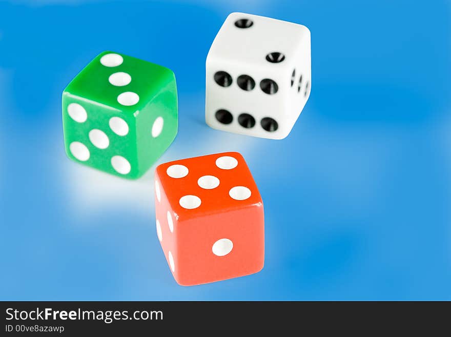 Three dice pieces on blue background, with clipping path