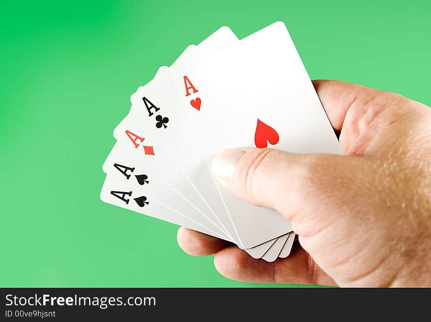 Five aces from a deck of cards held in hand