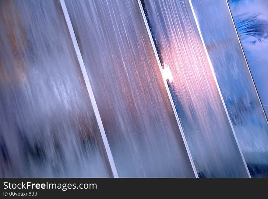 Blue abstract background -water runs on blue gass - sort focus. Blue abstract background -water runs on blue gass - sort focus