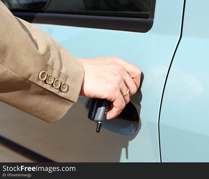 Men hand in jacket open car door. Men hand in jacket open car door