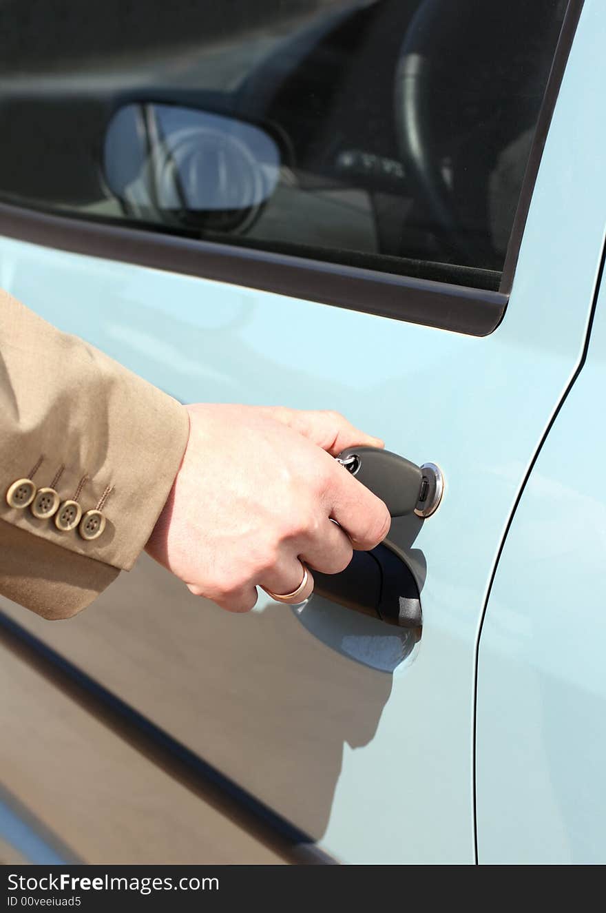 Men hand with key in jacket open car door. Men hand with key in jacket open car door