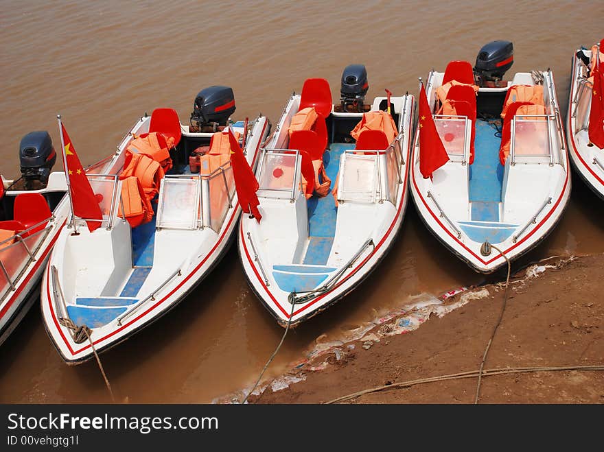 The motorboats by the muddy Yellow River, the muddiest river in the world. The motorboats by the muddy Yellow River, the muddiest river in the world.