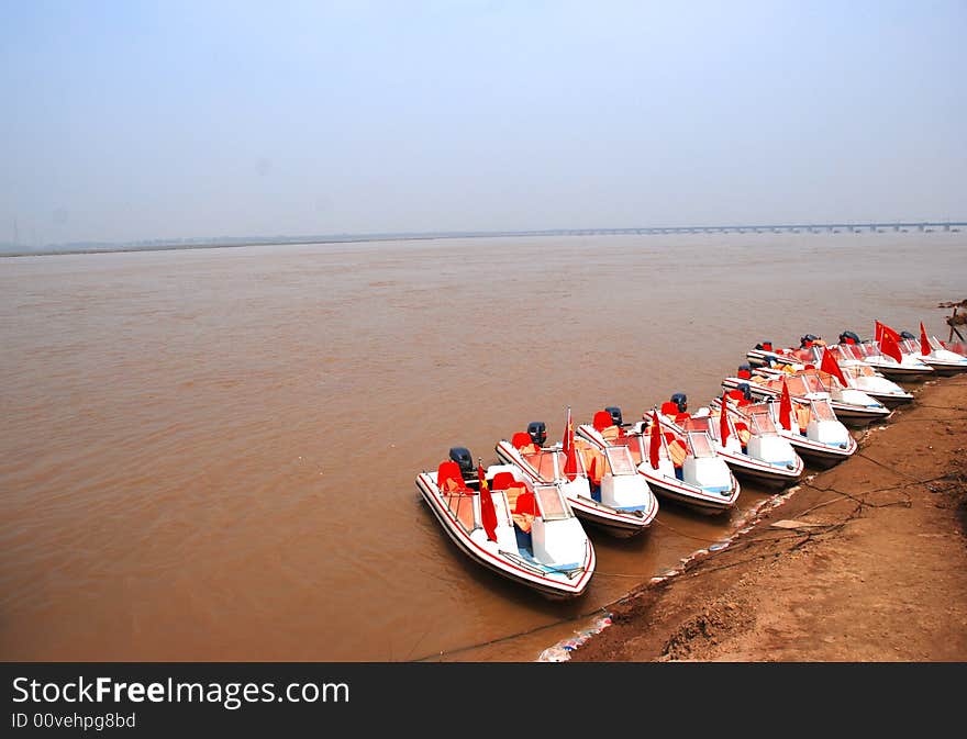 A file of motoboats by the Yellow River,central China,Henan,provinc. A file of motoboats by the Yellow River,central China,Henan,provinc.