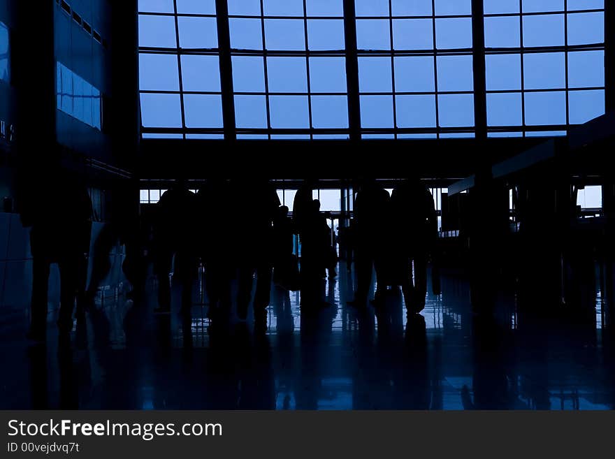 Black silhouettes of people in business center