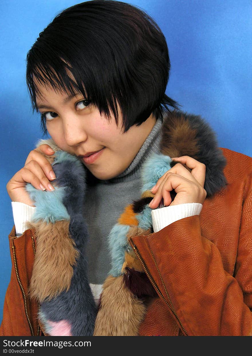 The girl in furs on blue background