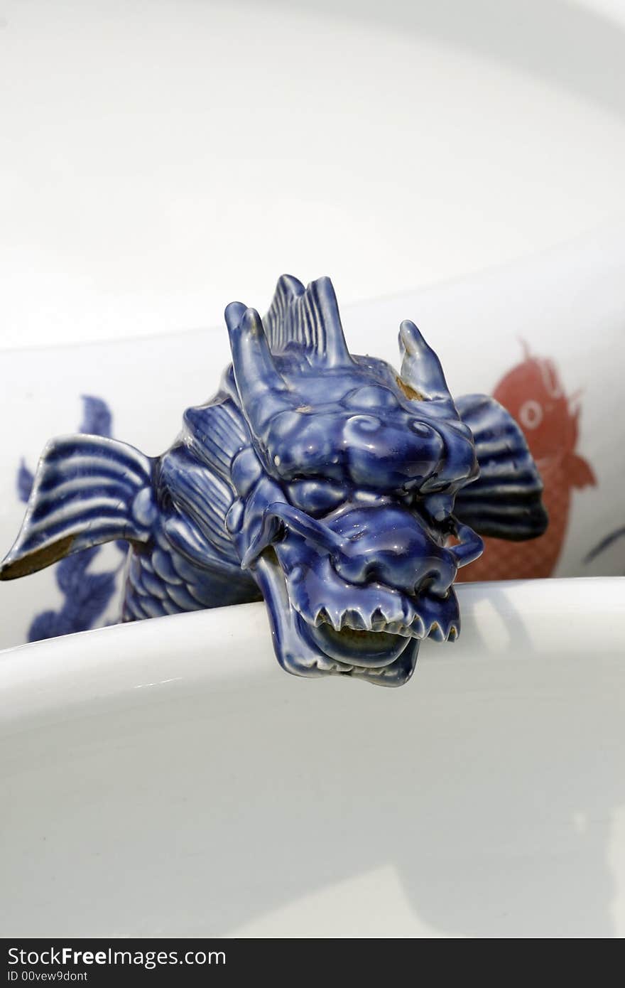 The Chinese porcelain is made decorating on the jar. Dragon shape. The Chinese porcelain is made decorating on the jar. Dragon shape.