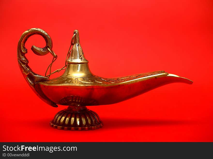 An isolated golden or bronze magic genie lamp, like Aladdin's! :)