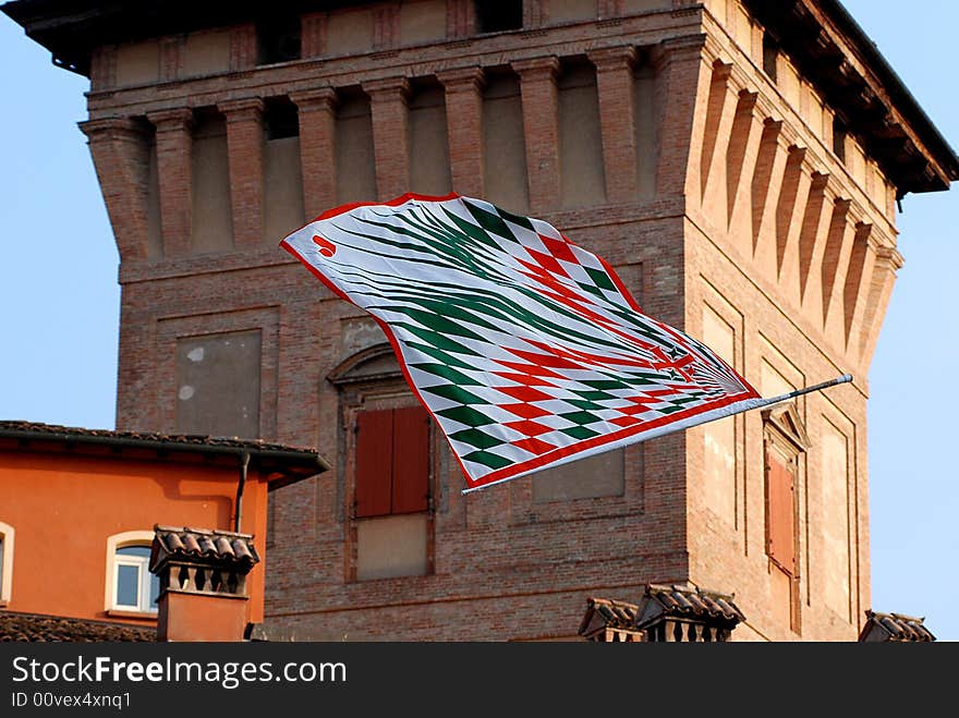 A flag fly near an old tower. A flag fly near an old tower