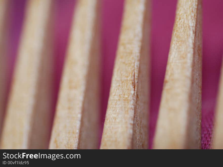 A close-up of a wooden comb, short depth of field. A close-up of a wooden comb, short depth of field