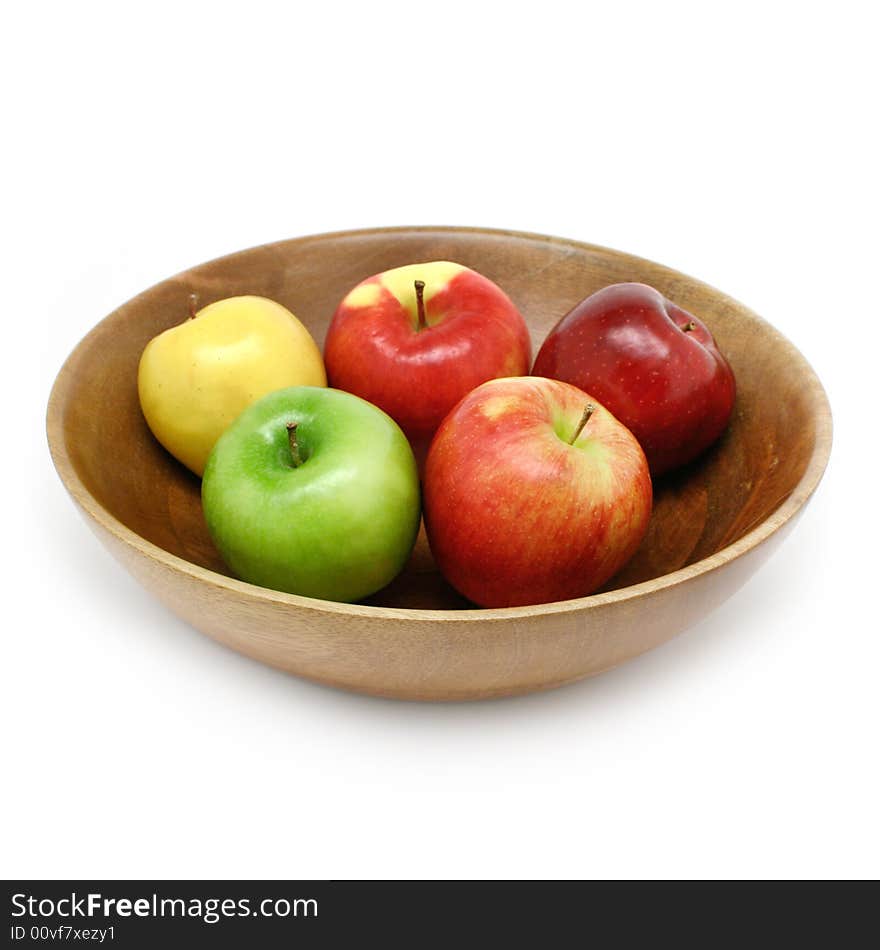 Fresh apples in a wooden bowl isolated on white. Fresh apples in a wooden bowl isolated on white