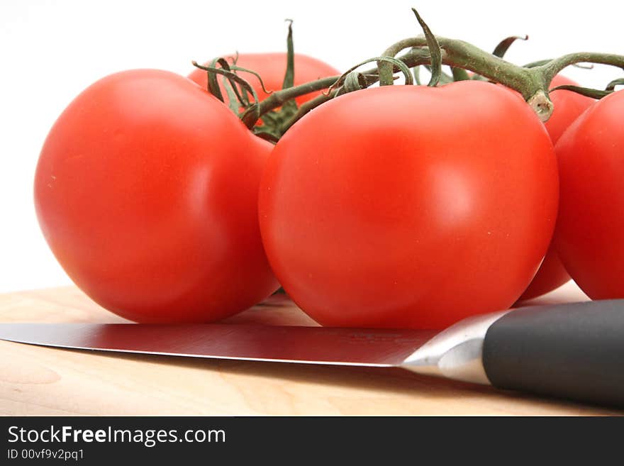 Fresh picked red vine tomatoes white background