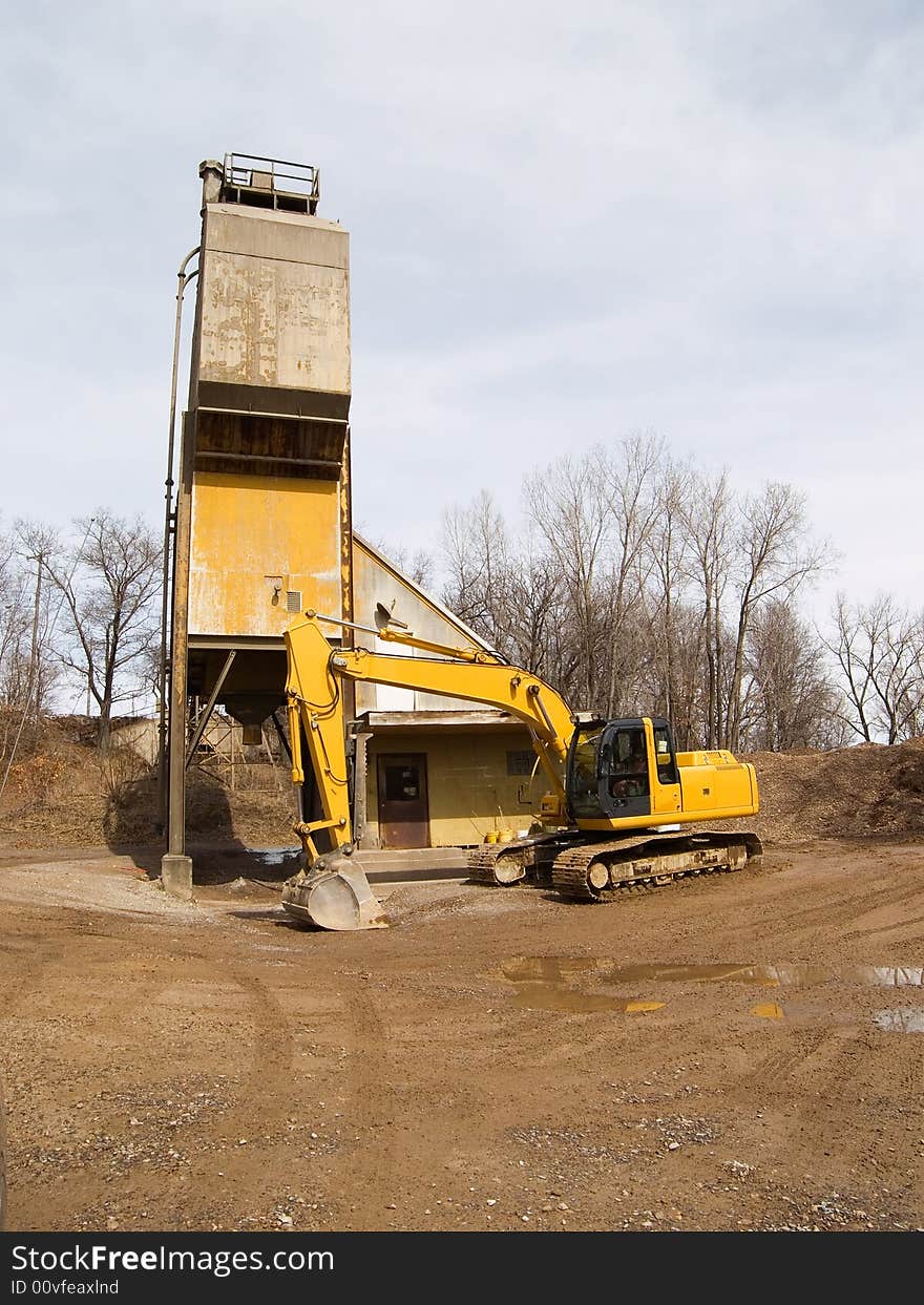 Excavator near a cement silo