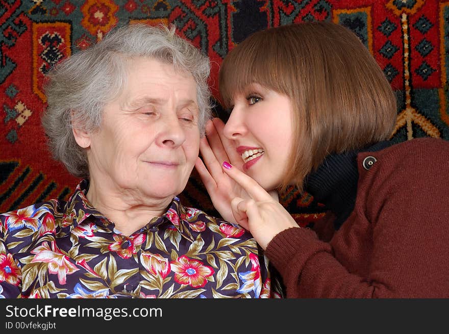 Grandmother and granddaughter gossiping