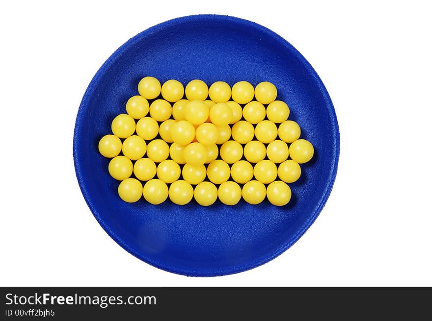 Blue plateful of yellow drops vitamin