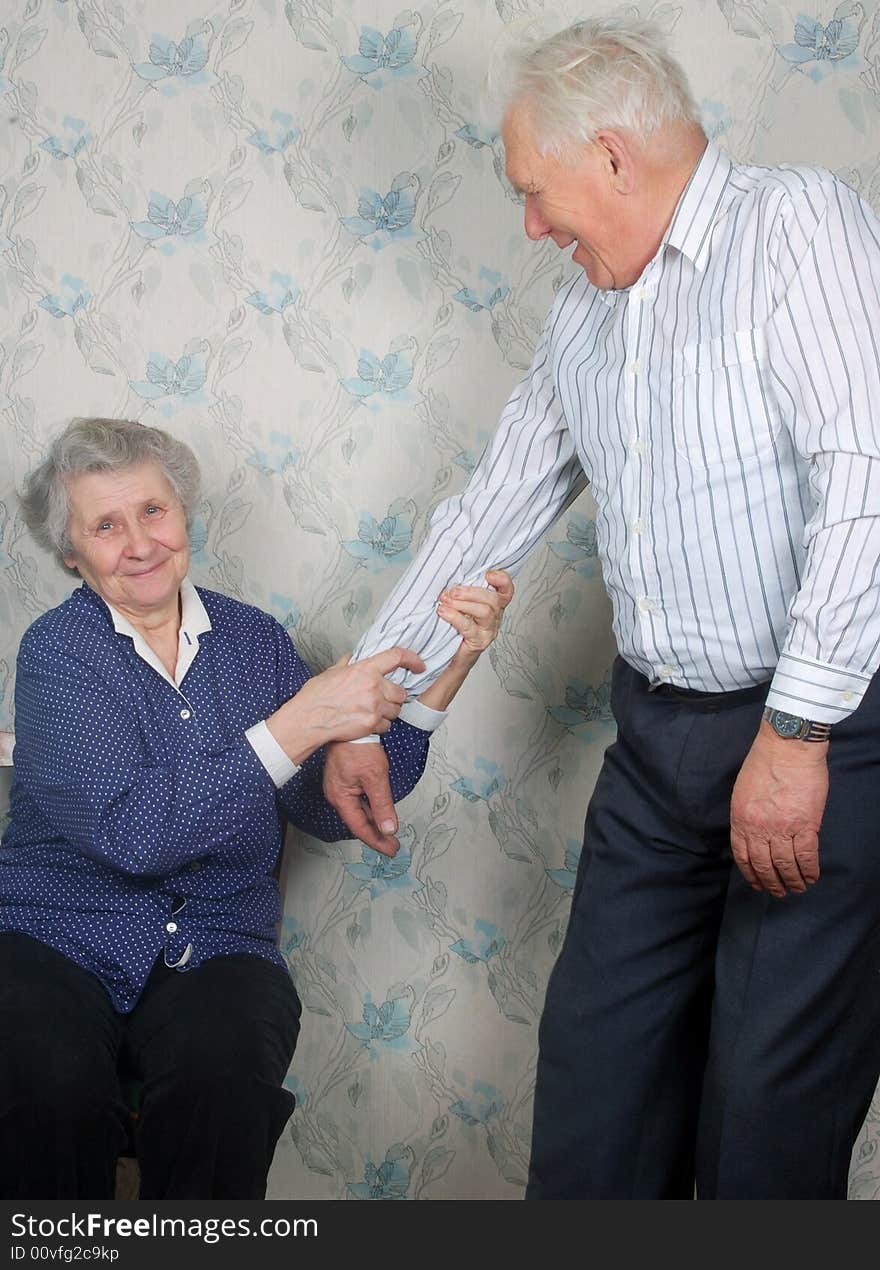 Happy old couple play the fool at home