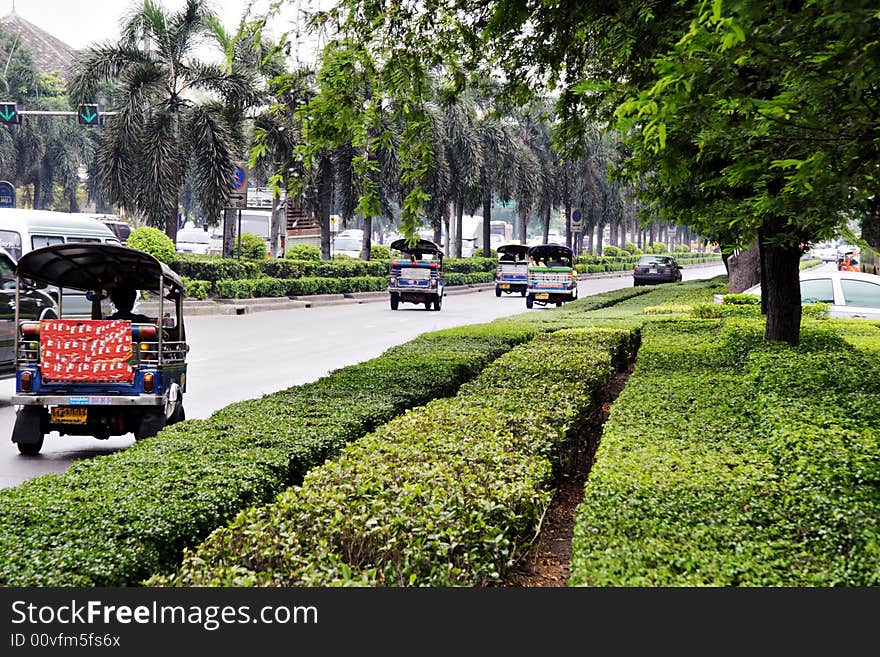 Auto rickshaws driving on road
