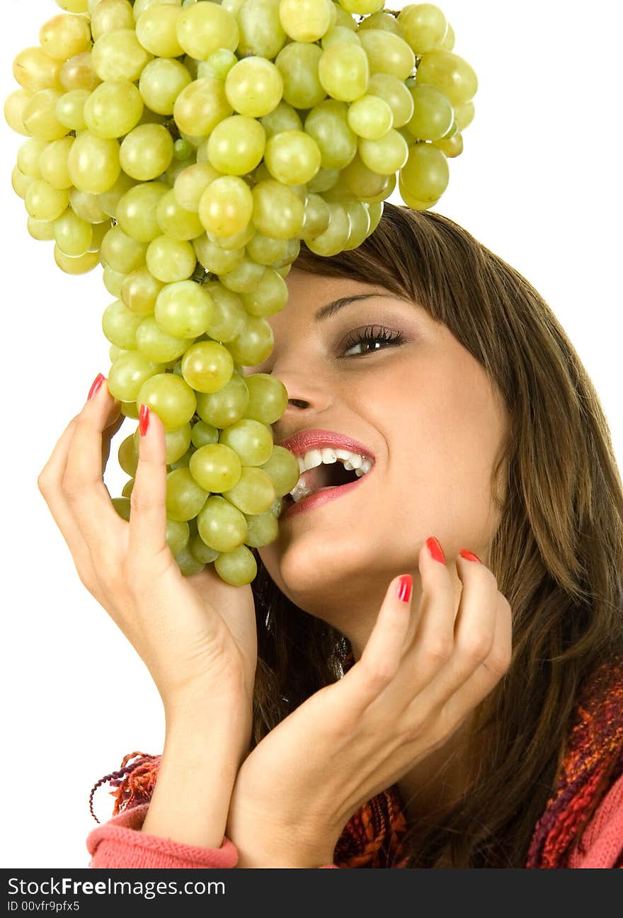 Young woman eating grapes. Isolated on white.