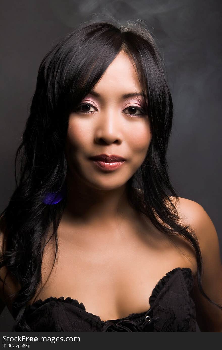 Portrait of a beautiful asian american in black background. Portrait of a beautiful asian american in black background.