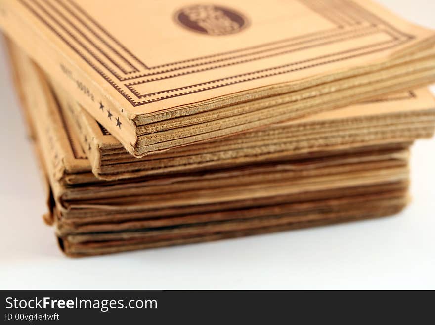 A pile of antique books against a white background