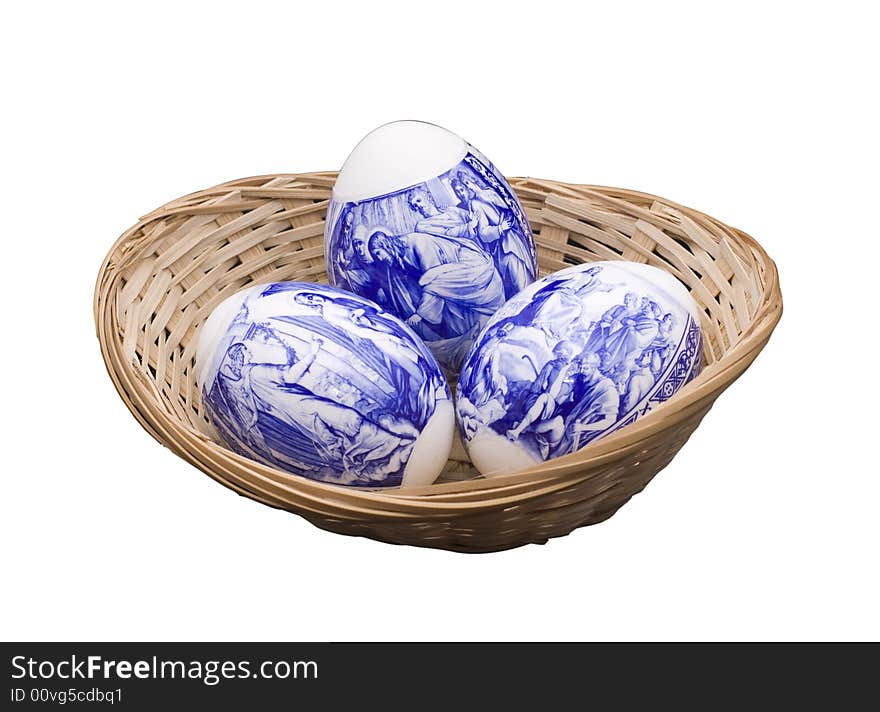 Easter eggs in a basket on the isolated white background