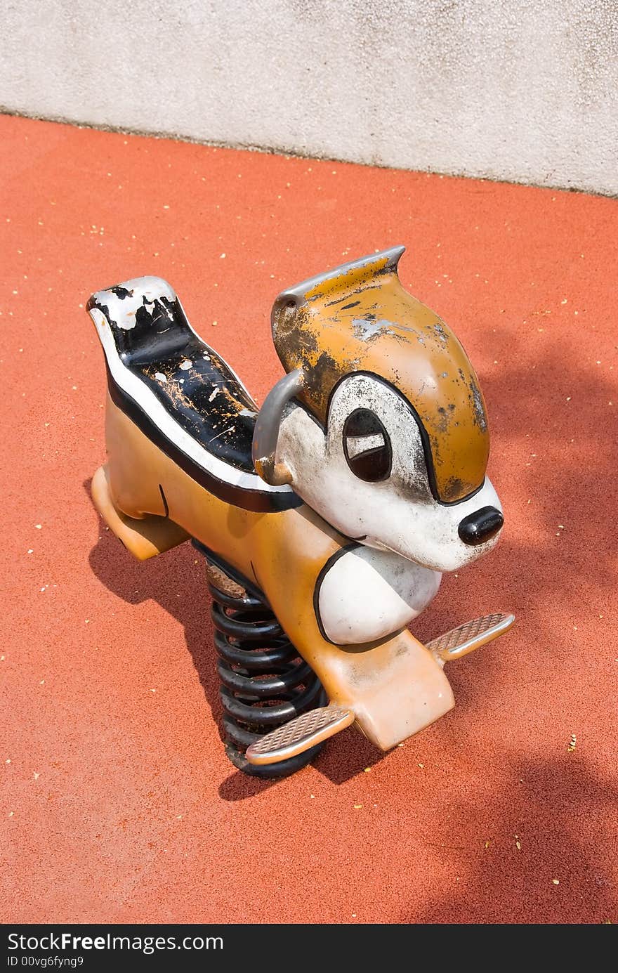 Old and worn playground toy horse