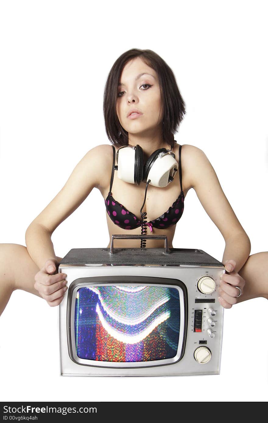 A beautiful young woman sits behind tv. A beautiful young woman sits behind tv