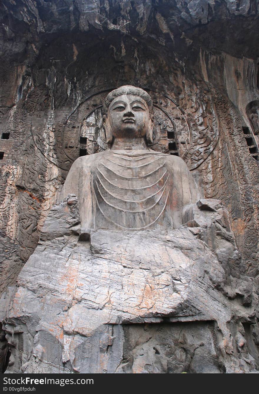 The stone statue of Budda chiseled out of the mountain stone,Longmen Grottoes,Luoyang,Henan,China,Asia. The stone statue of Budda chiseled out of the mountain stone,Longmen Grottoes,Luoyang,Henan,China,Asia.