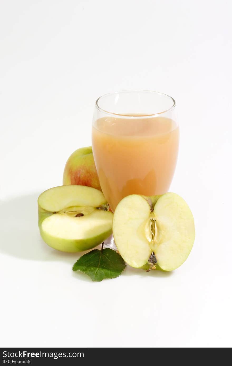 A glass of apple juice with fresh apples on bright background. A glass of apple juice with fresh apples on bright background