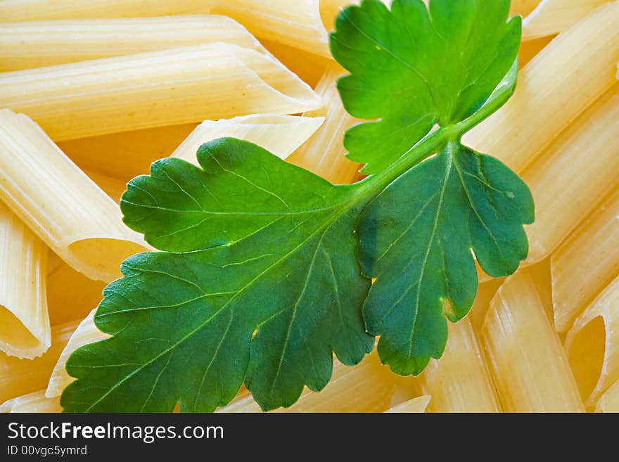 Macaroni with a leaf of parsley close up. Macaroni with a leaf of parsley close up