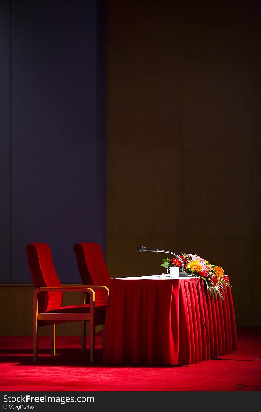 Podium isolated on black background with microphone and red table. Podium isolated on black background with microphone and red table