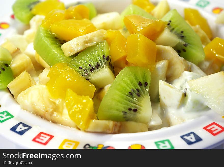 Fruit salad from kiwi, a banana, an apple and a mango