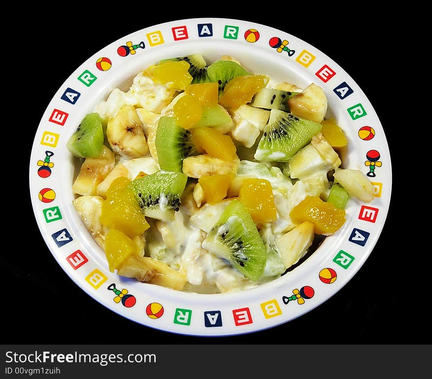 Fruit salad in a plate isolated on a black background