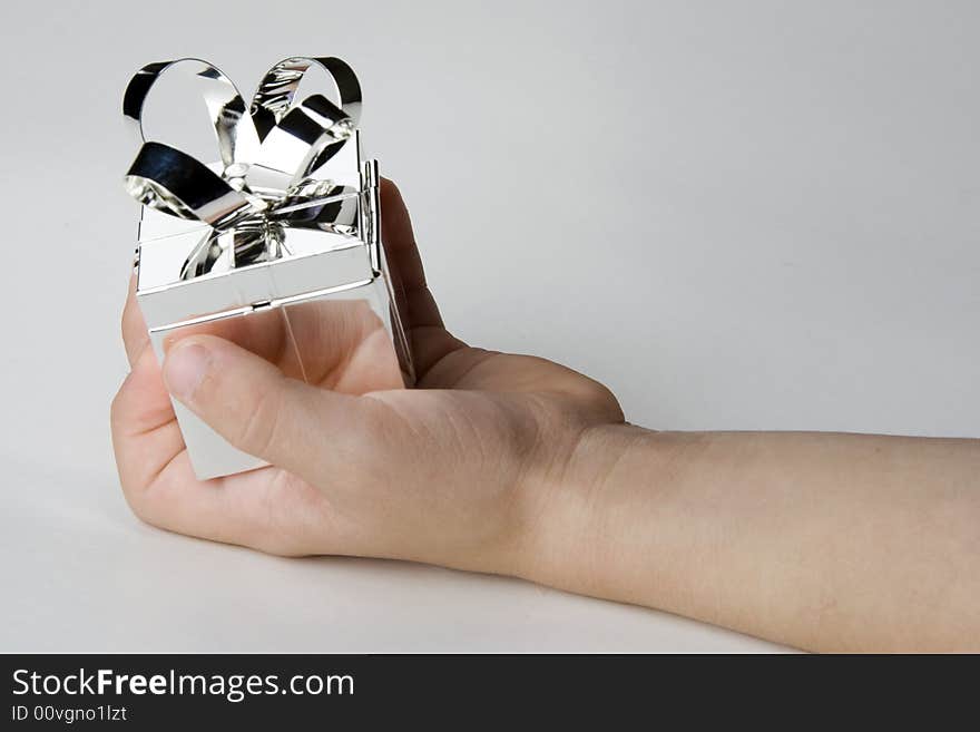 Silver jewlery box holded by a child´s  hand. Silver jewlery box holded by a child´s  hand