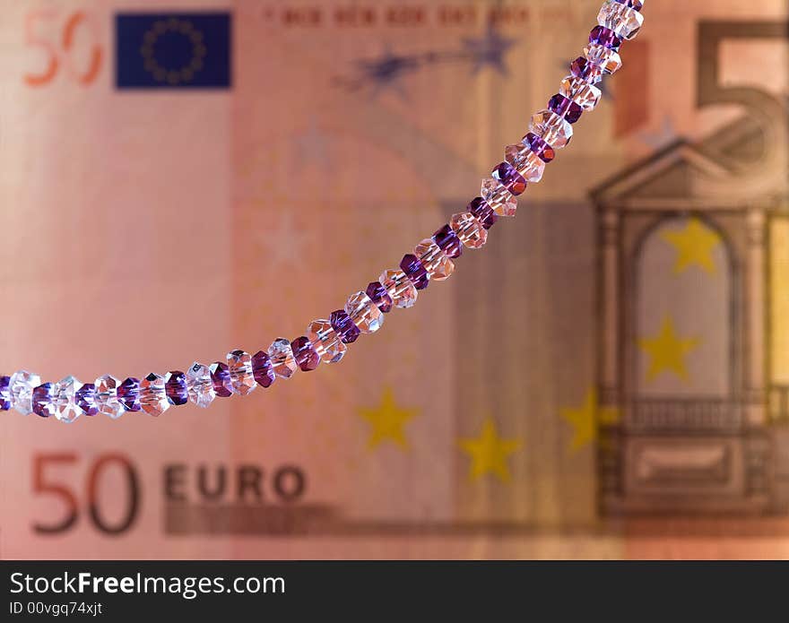 Necklace on a background of a banknote. Shallow depth of field. Necklace on a background of a banknote. Shallow depth of field.