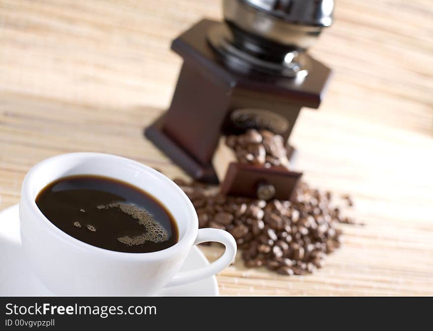 Black coffee, grinder and coffee beans