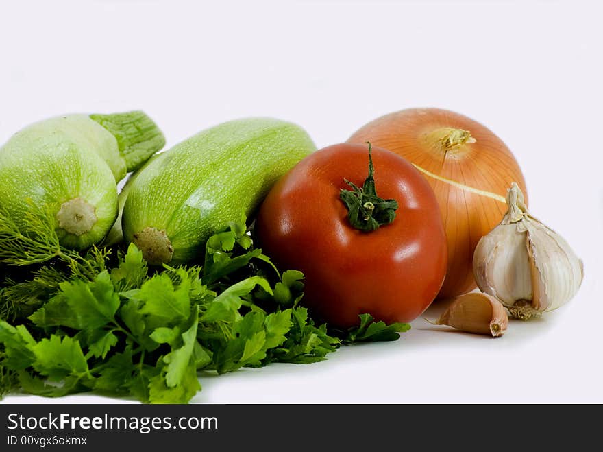 Zucchinis and tomato isolated on white background. Zucchinis and tomato isolated on white background