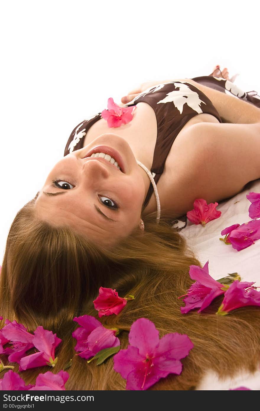 Beautiful woman lying down, azaleas spread through hair. Beautiful woman lying down, azaleas spread through hair.