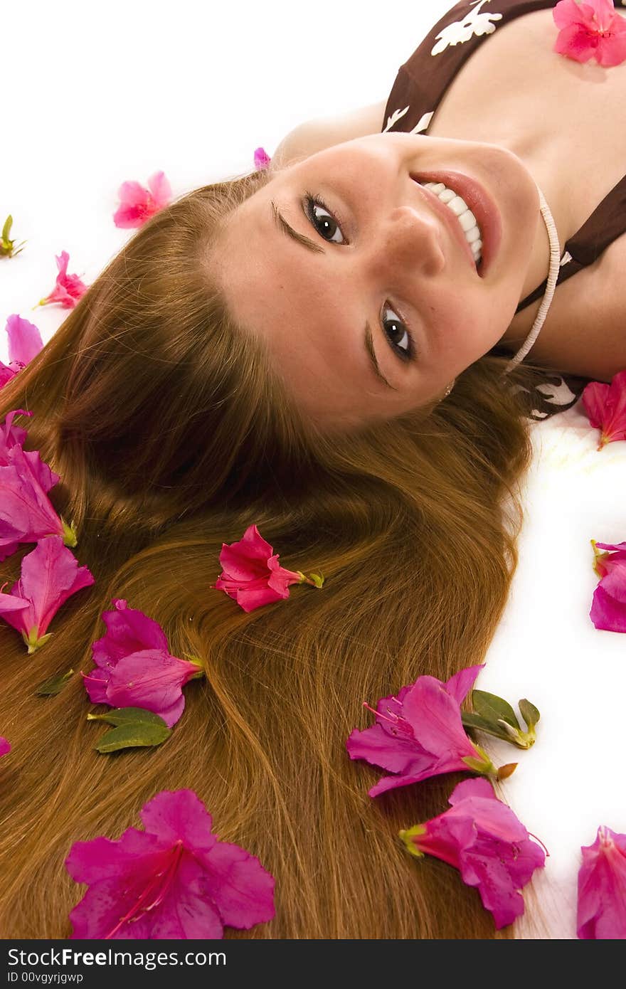 Beautiful woman lying down, azaleas spread through hair. Beautiful woman lying down, azaleas spread through hair.