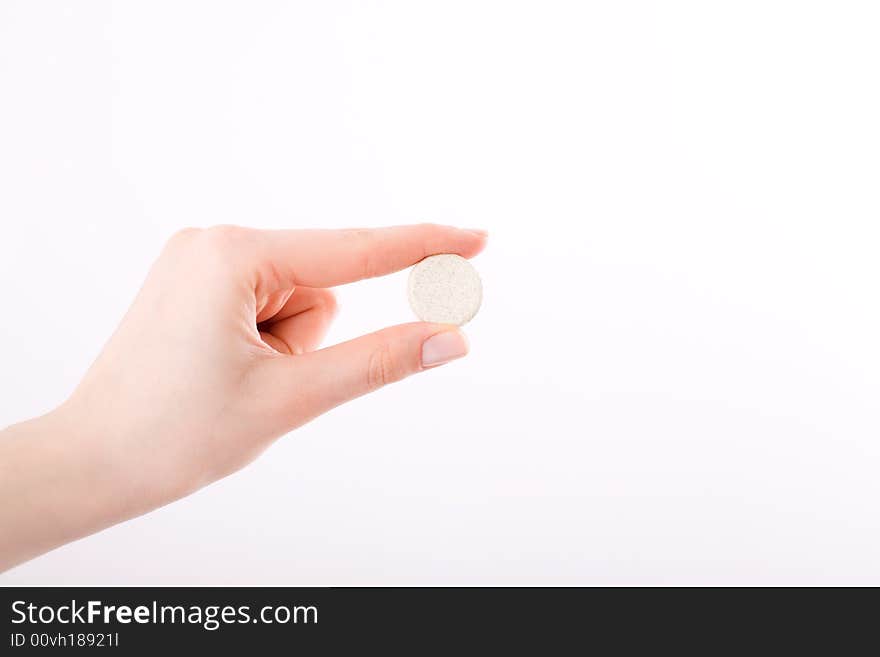 Female hand keeping the pill