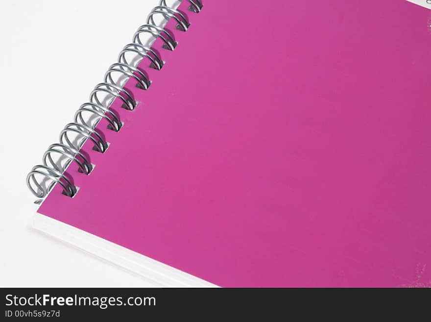 Pink notebook on a white background