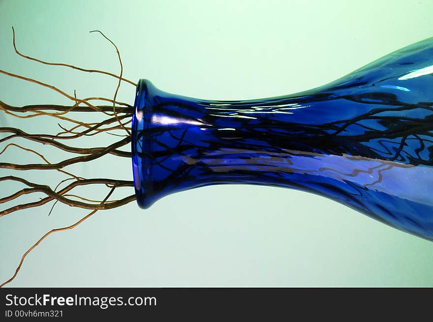 Blue glass vase with a lot of wood branches. Blue glass vase with a lot of wood branches