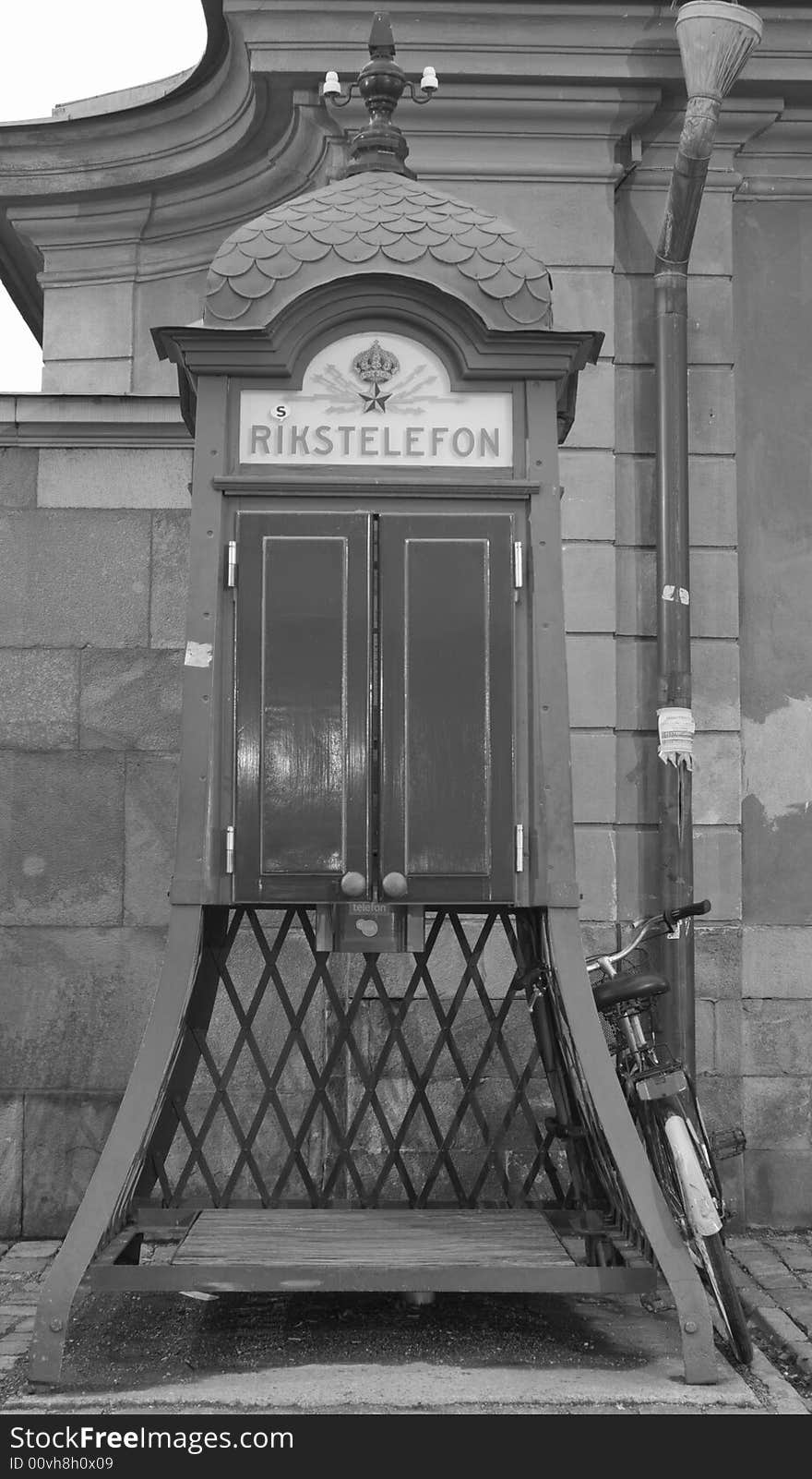 An old public telephone and a bike