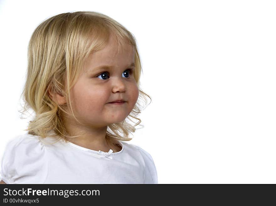 Blond baby girl with a cute expression. Blond baby girl with a cute expression.