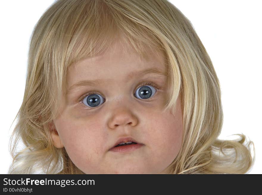 Blond baby girl with surprised looked on her face. Blond baby girl with surprised looked on her face.