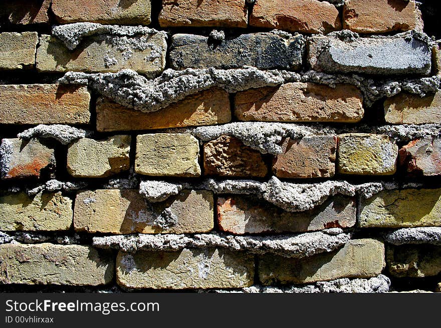 Detail shot of an old textured brick wall with mortar coming out. Detail shot of an old textured brick wall with mortar coming out